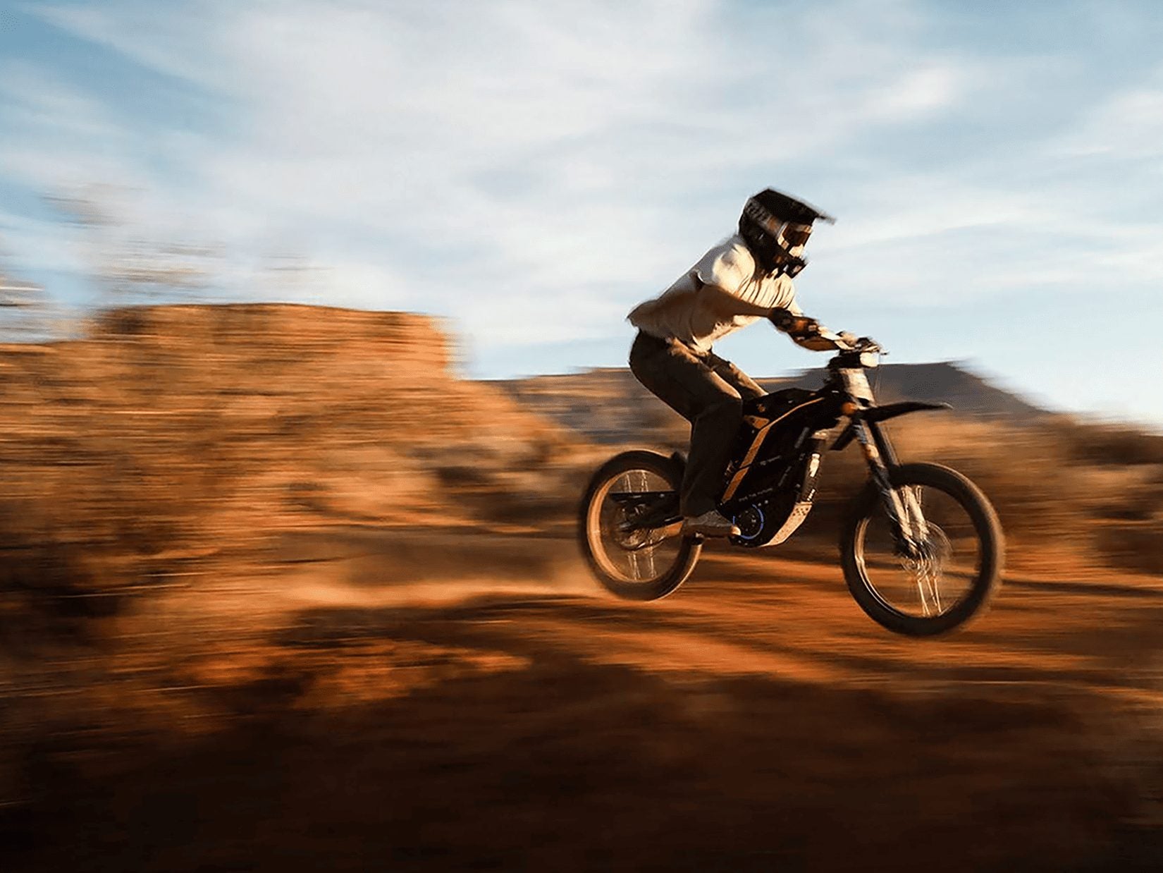 Electric dirt bike rider on a dirt trail
